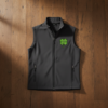 Flat lay of battleship grey soft shell vest with embroidered four-leaf clover on wooden background
